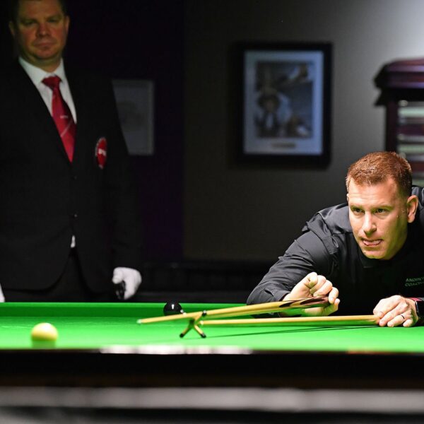 Andrew Norman plays a shot with the rest.