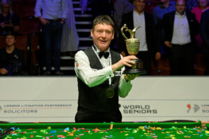 Jimmy White lifts the World Seniors Snooker Championship trophy.