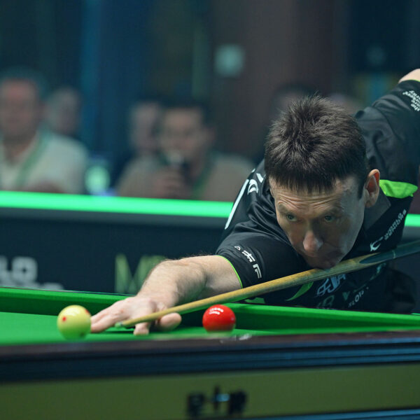 Jimmy White plays a shot.